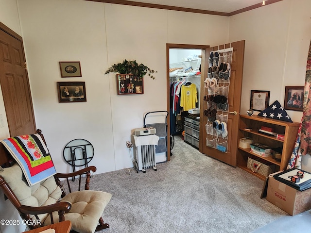 sitting room with carpet floors and ornamental molding