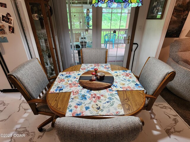 dining room with marble finish flooring