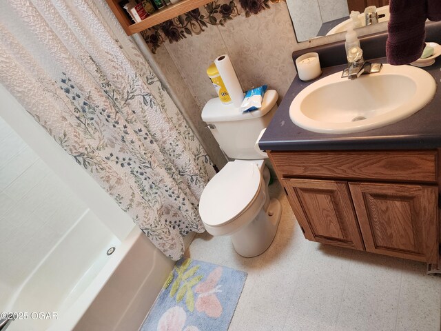 bathroom with vanity, toilet, and shower / bathtub combination with curtain