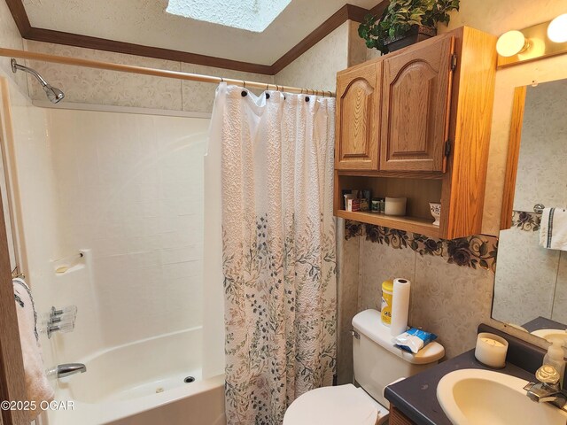 full bathroom featuring a skylight, shower / bath combination with curtain, toilet, wallpapered walls, and vanity