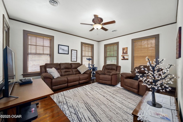 living room with ceiling fan, crown molding, and dark wood finished floors