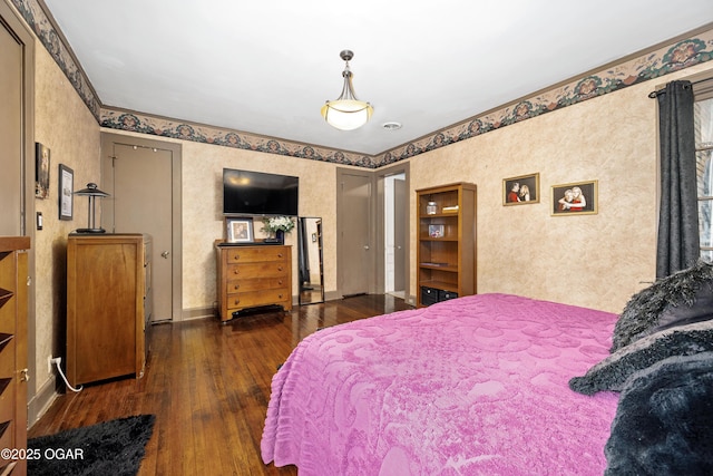 bedroom featuring hardwood / wood-style flooring and wallpapered walls
