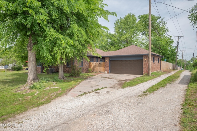 view of front of home with driveway, brick siding, an attached garage, and roof with shingles
