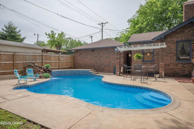 view of pool with a patio and fence