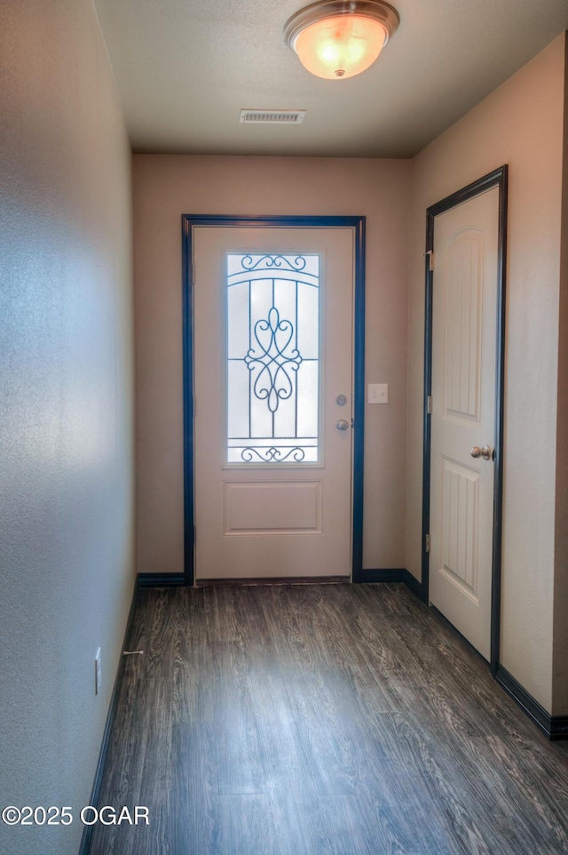 entryway featuring wood finished floors and baseboards