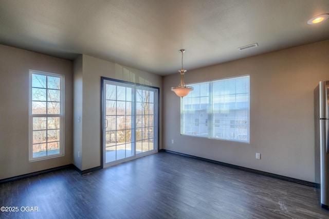 unfurnished dining area featuring dark wood-style floors, baseboards, and recessed lighting