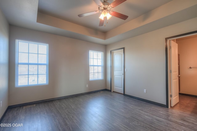 unfurnished bedroom featuring wood finished floors and baseboards