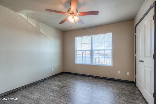 unfurnished bedroom featuring wood finished floors, baseboards, and a ceiling fan