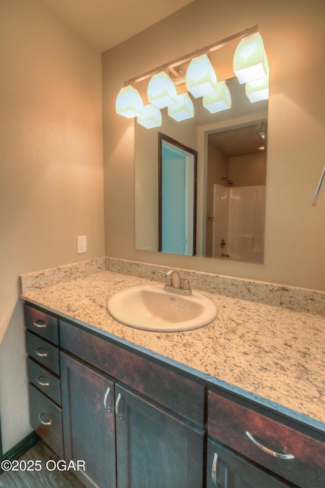bathroom with vanity and a shower