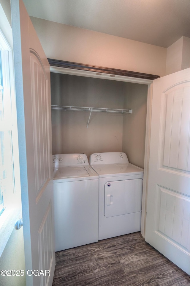 laundry room featuring washing machine and clothes dryer and dark wood-style flooring