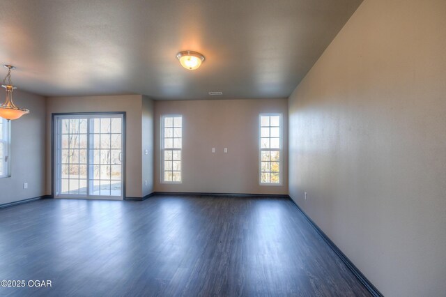 empty room with wood finished floors and baseboards