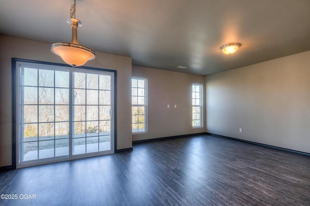 empty room featuring wood finished floors and baseboards