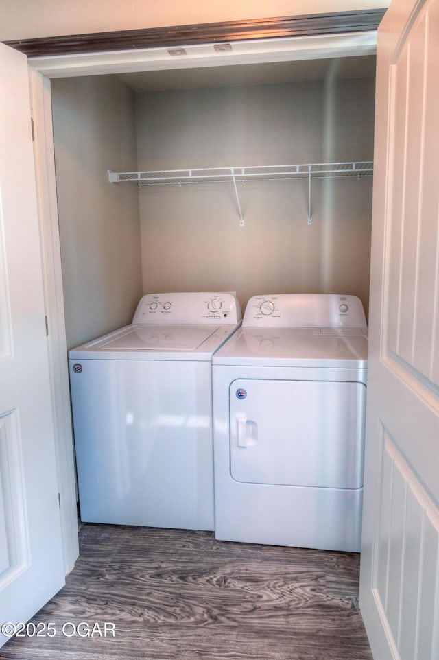 laundry room featuring washing machine and dryer and dark wood finished floors