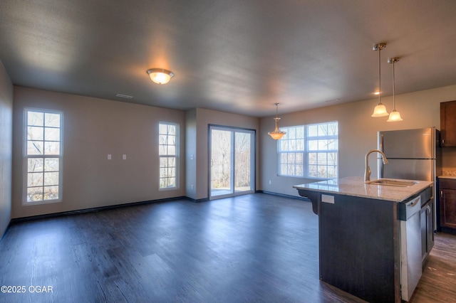 kitchen featuring dishwasher, dark wood-style floors, a kitchen bar, baseboards, and light stone countertops