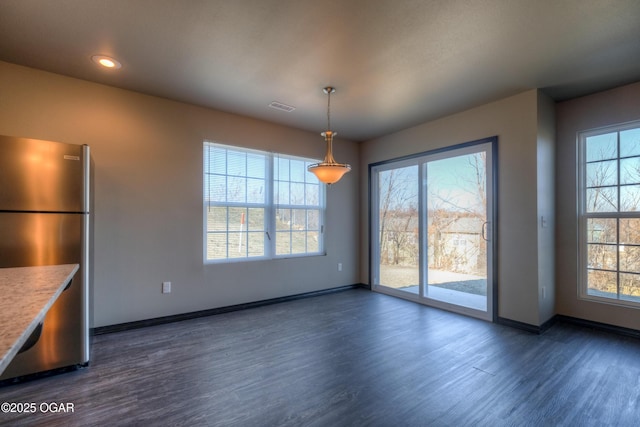unfurnished dining area featuring dark wood finished floors, baseboards, and recessed lighting