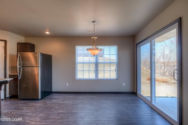 unfurnished dining area with dark wood-style floors, baseboards, and recessed lighting