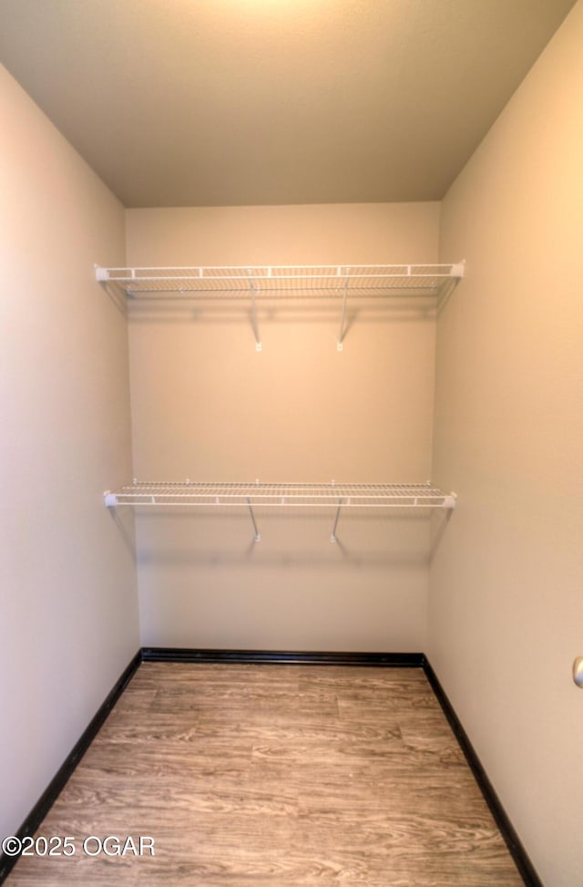 spacious closet with wood finished floors