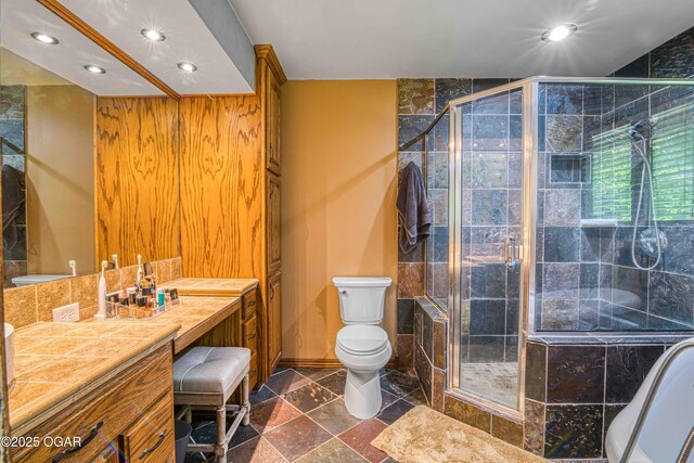 bathroom featuring recessed lighting, a shower stall, toilet, vanity, and a tub to relax in