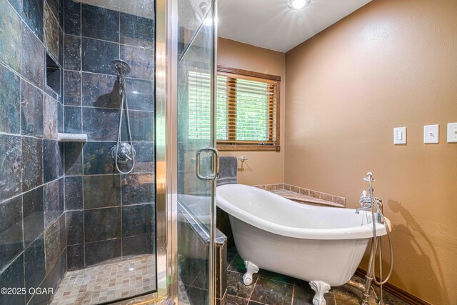 full bathroom featuring a shower stall and a freestanding tub