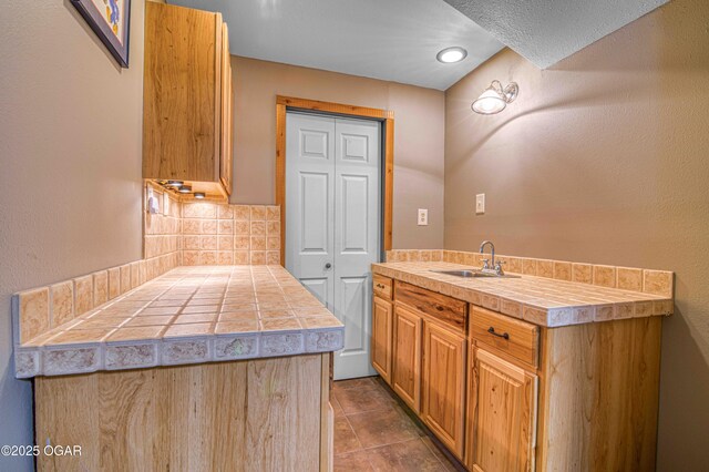 bathroom with tasteful backsplash, vanity, and tile patterned floors