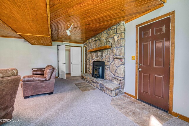 tiled living area featuring wood ceiling, baseboards, a fireplace, and carpet floors