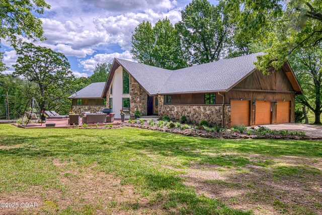 view of front of house with stone siding, outdoor lounge area, a front lawn, a shingled roof, and driveway