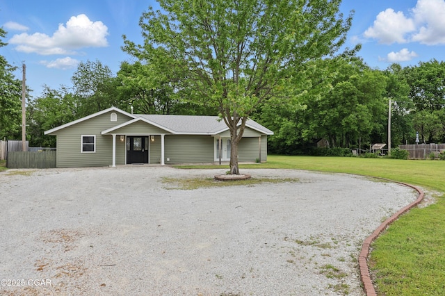 single story home featuring gravel driveway