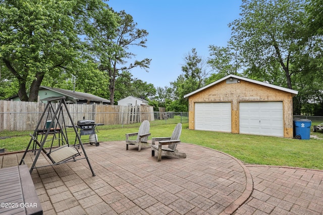 view of patio / terrace featuring a detached garage, a grill, and an outdoor structure