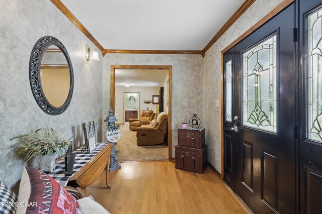 entrance foyer with light wood-style flooring and crown molding