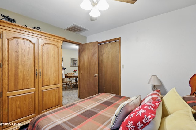 carpeted bedroom featuring ceiling fan and a closet