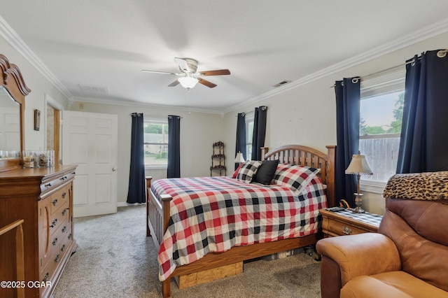 bedroom featuring light colored carpet, ornamental molding, and ceiling fan