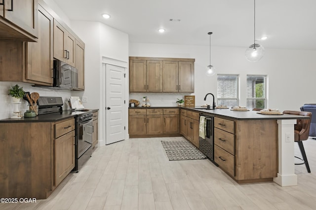 1318 Foundry Dr, Carthage, MO 64836 - kitchen with black range with electric stovetop, a peninsula, dishwashing machine, a kitchen breakfast bar, and a sink