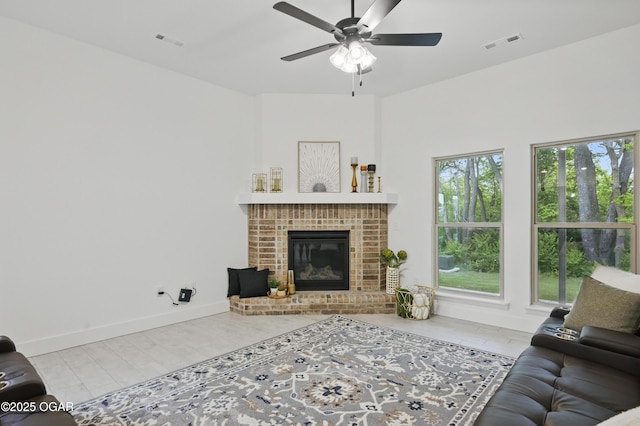 1318 Foundry Dr, Carthage, MO 64836 - living area featuring ceiling fan, a fireplace, and baseboards