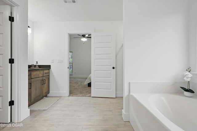 1318 Foundry Dr, Carthage, MO 64836 - bathroom with ceiling fan, vanity, a bath, ensuite bath, and wood finished floors
