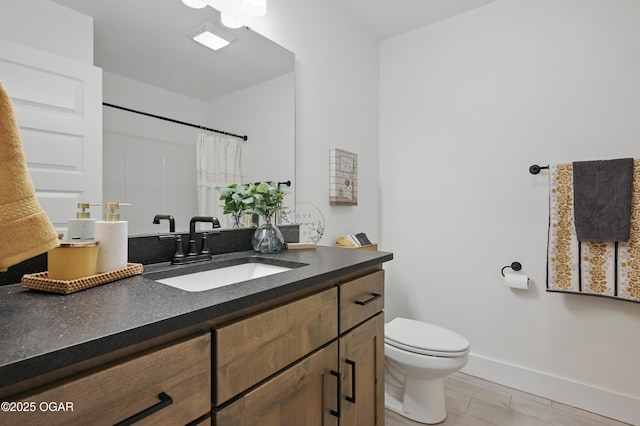 1318 Foundry Dr, Carthage, MO 64836 - bathroom with toilet, vanity, baseboards, and curtained shower