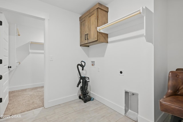 1318 Foundry Dr, Carthage, MO 64836 - laundry room with cabinet space, washer hookup, hookup for an electric dryer, baseboards, and light wood-type flooring