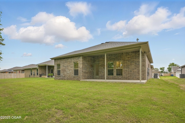 1318 Foundry Dr, Carthage, MO 64836 - rear view of house featuring brick siding, central air condition unit, and a patio area