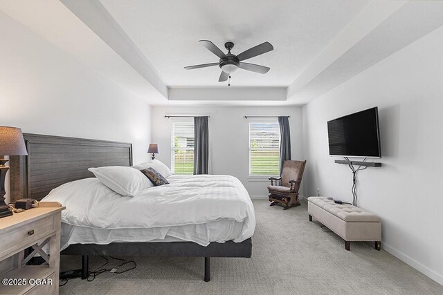 1528 N Edgemont Cir, Springfield, MO 65802 - carpeted bedroom with a tray ceiling, baseboards, and a ceiling fan