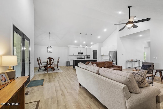 1528 N Edgemont Cir, Springfield, MO 65802 - living area with high vaulted ceiling, light wood-style floors, ceiling fan, recessed lighting, and baseboards