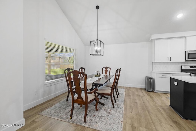 1528 N Edgemont Cir, Springfield, MO 65802 - dining area featuring baseboards, light wood-type flooring, a chandelier, and high vaulted ceiling