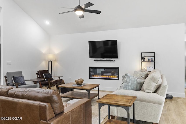 1528 N Edgemont Cir, Springfield, MO 65802 - living room with ceiling fan, vaulted ceiling, a glass covered fireplace, light wood-type flooring, and baseboards