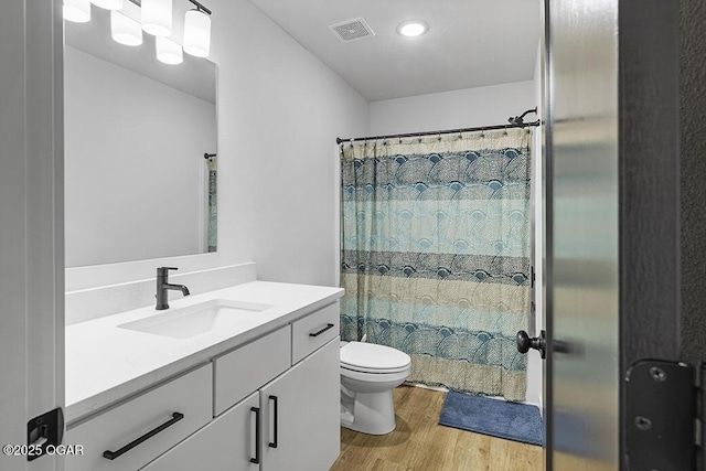 1528 N Edgemont Cir, Springfield, MO 65802 - full bathroom with wood finished floors, toilet, vanity, and curtained shower