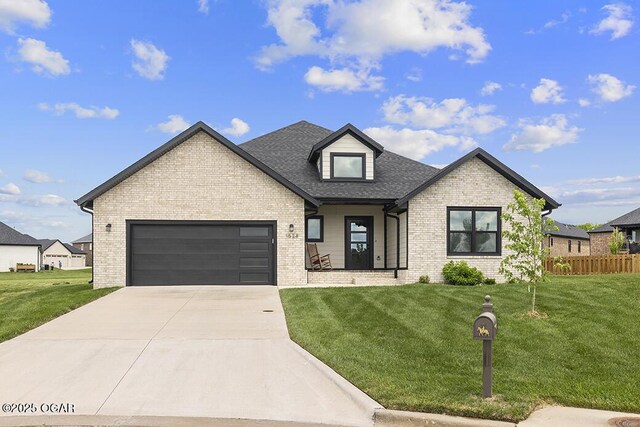 1528 N Edgemont Cir, Springfield, MO 65802 - view of front of house featuring brick siding, a garage, driveway, and roof with shingles