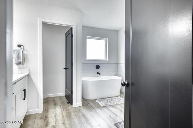 1528 N Edgemont Cir, Springfield, MO 65802 - full bath with wood finished floors, a freestanding bath, vanity, and baseboards