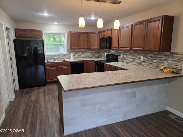 101 Van Hooser Blvd, Carl Junction, MO 64834 - kitchen with black appliances, a sink, dark wood-style floors, light countertops, and a peninsula