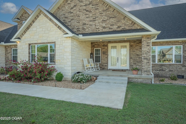 8740 County Road 241, Webb City, MO 64870 - view of front of property featuring covered porch, roof with shingles, a front lawn, brick siding, and stone siding