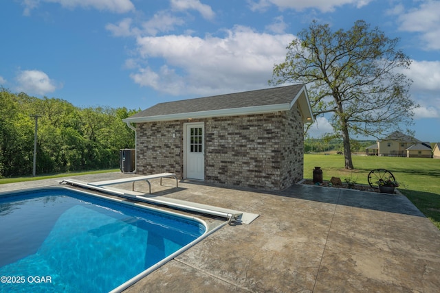 8740 County Road 241, Webb City, MO 64870 - view of pool featuring a diving board, a covered pool, a lawn, an outdoor structure, and a patio area