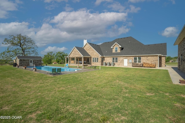 8740 County Road 241, Webb City, MO 64870 - rear view of house featuring an outdoor pool, an outdoor structure, a chimney, brick siding, and a yard
