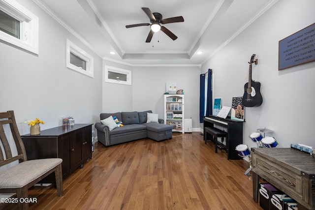 8740 County Road 241, Webb City, MO 64870 - living room featuring ceiling fan, wood finished floors, a raised ceiling, crown molding, and recessed lighting