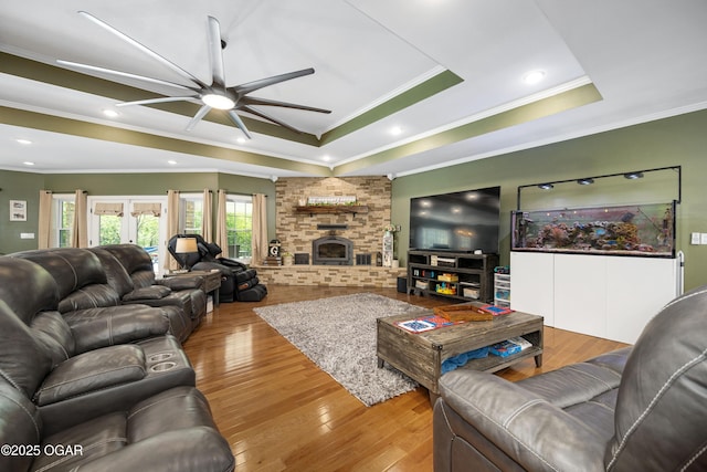 8740 County Road 241, Webb City, MO 64870 - living room with a raised ceiling, ceiling fan, ornamental molding, wood finished floors, and a fireplace